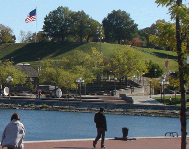 Federal Hill Park Viewed From Harborplace Waterfront Promenade with Replica US Flag that inspired Francis Scott Key to write our National Anthem Baltimore MD