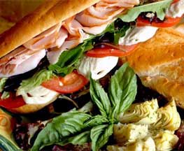 Image of Isabella's delicious mouthwatering Italian Sub on fresh in-store baked bread with authentic Italian meats, homemade mozzarella cheese with fresh greens, tomatoes and artichoke hearts Little Italy Baltimore MD