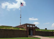 Image of entrance to Fort McHenry with replica of 1812 U. S. flag & information placard in foreground Locust Point, Baltimore, MD