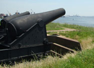 Image of huge black Fort McHenry cannons aimed out towards the Patapsco River as they were in the War of 1812 Locust Point, Baltimore, MD